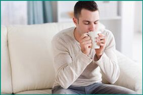 A man drinks peppermint tea to treat erectile dysfunction. 
